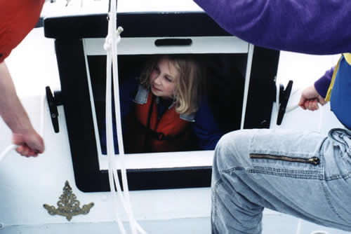 Aly watches as her parents set sail